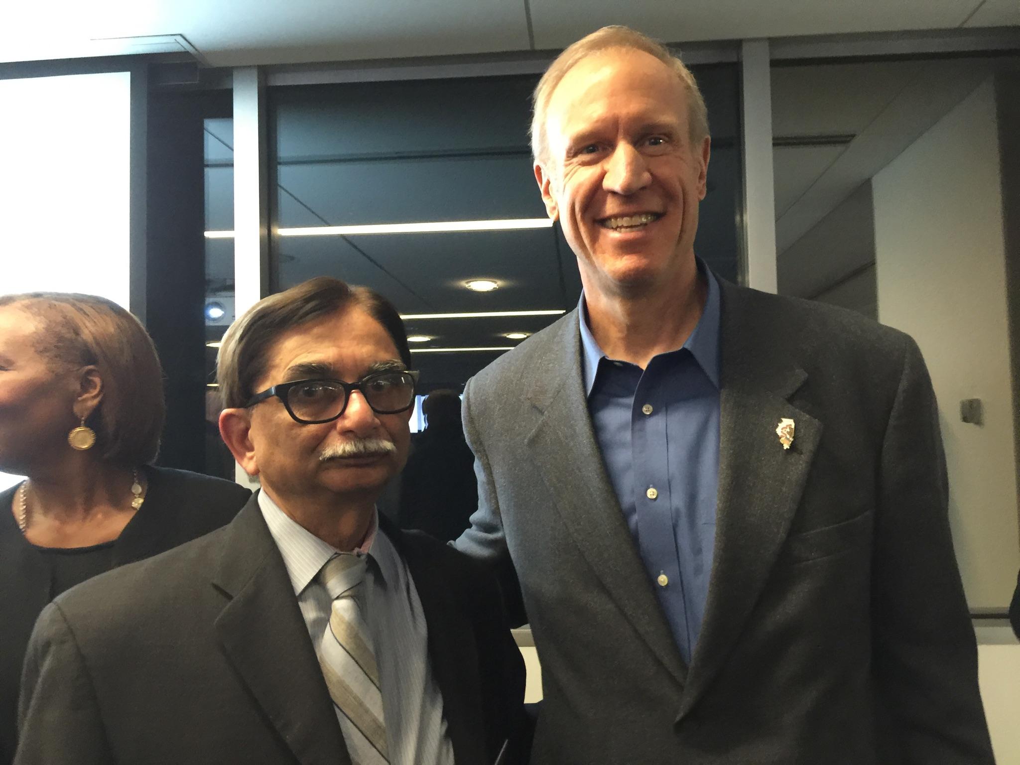 Illinois REALTOR® Pradeep Shukla meets with Illinois Gov. Bruce Rauner at an announcement on Feb. 3 about changes to how the state handles economic development. 