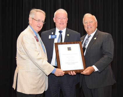 REALTOR® Martin Edwards from Memphis presents Illinois REALTORS® President Mike Drews and CEO Gary Clayton with a plaque commemorating the association's 100th birthday at a lunch held in Washington, D.C., on May 13, 2016.