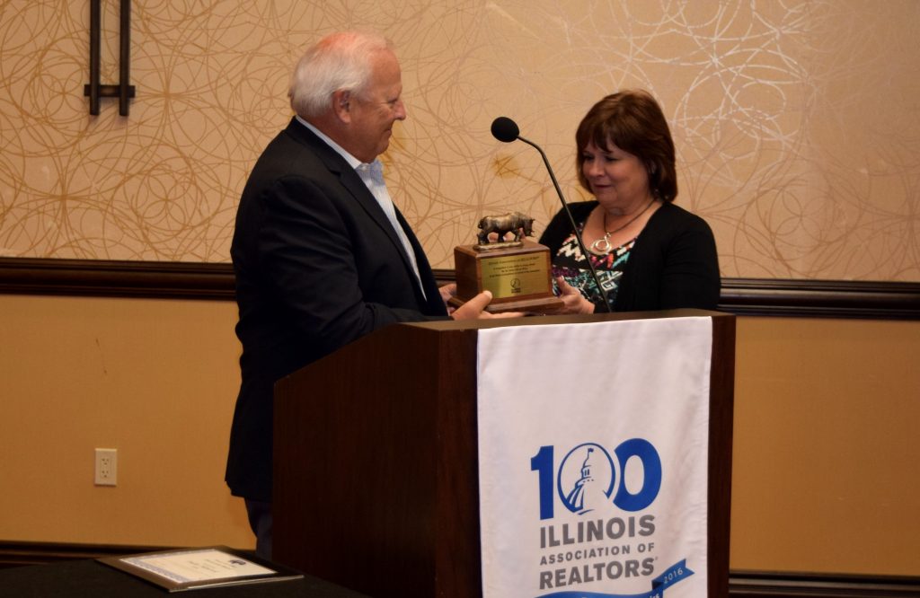 Peoria Area Association of REALTORS® CEO Dallas Hancock receives the Rhino Award from Illinois REALTORS® CEO Gary L. Clayton.