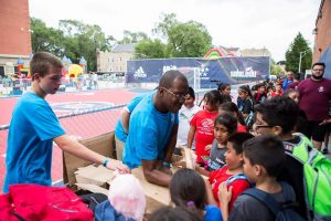 Hampton gets plenty of help opening a box. (Jack Lane photo)