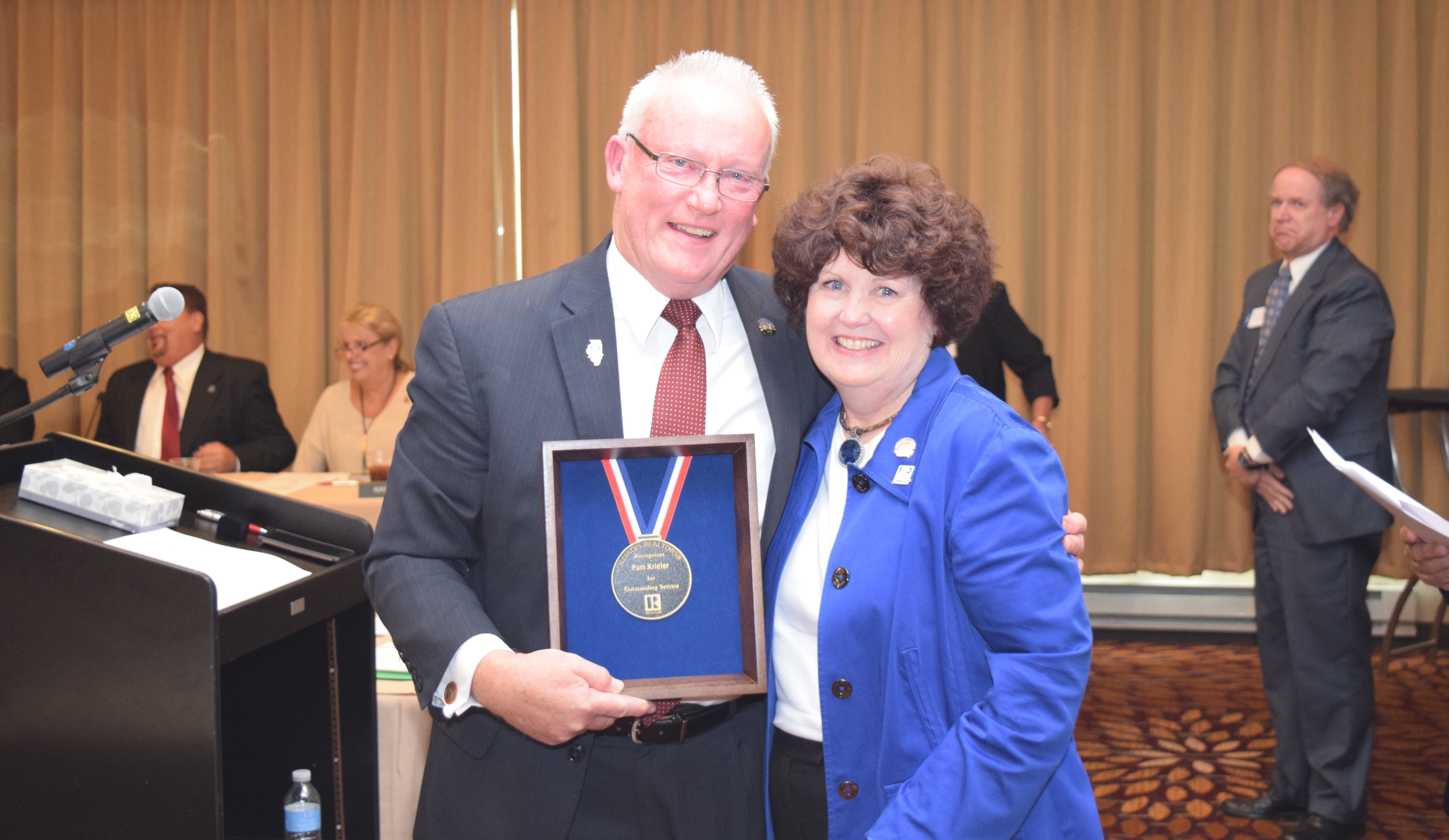 Mainstreet Organization of REALTORS® CEO Pam Krieter is honored for her longstanding service to the real estate industry with a Presidential Medalion. 