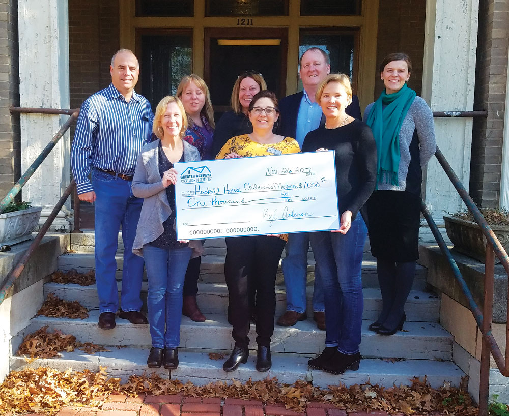 BicentennialProjectsPhoto01 REALTOR® Laurie Moore, president of the Greater Gateway Association of REALTORS® (center) presents a $1,000 check to the board of directors of the Haskell House Children’s Museum in Alton.