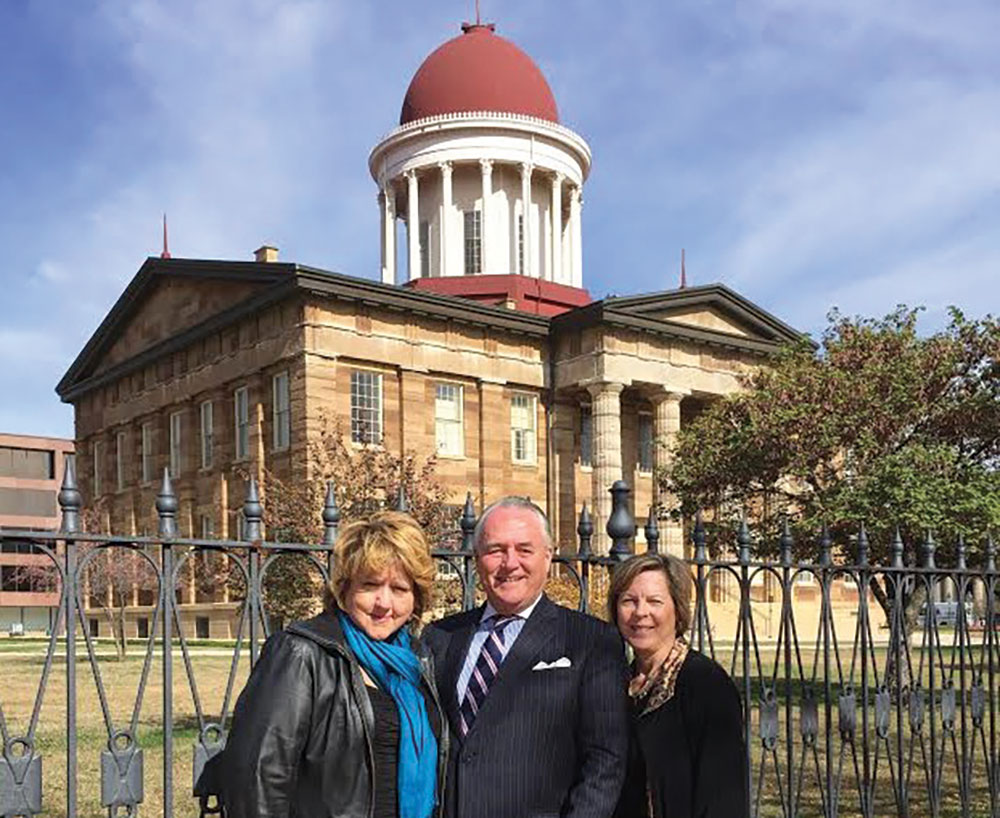 Vicky Turner, Jim Kinney and Sheryl Grider Whitehurst stand in front of the Old State Capitol in Springfield.