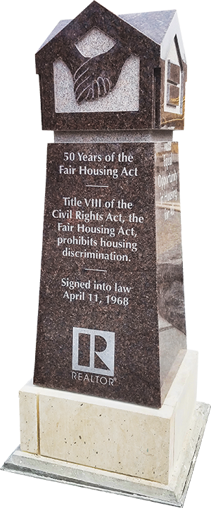 A monument commemorating the federal Fair Housing Act stands in Bicentennial Plaza — A REALTOR® Community Partnership, outside the association's Springfield headquarters.