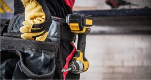 Closeup photo of tool belt on construction worker. Includes power tool.