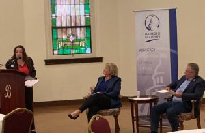 Collinsville REALTOR® Kris Rosser Schmitt speaks at the podium
