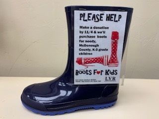 Photo of child's boot with sign for "Boots for Kids" campaign