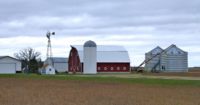a barn, a silo, a windmill and other farm buildings