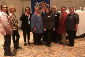 Nine REALTORS® pose for a group photo at the Drury Lane Theater and Conference Center in Oakbrook Terrace.